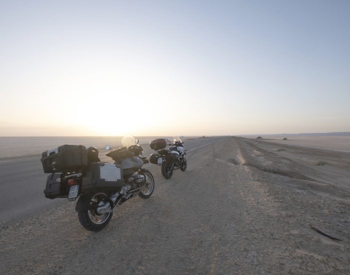 Two bikes parked at the lake bed of the Chott el Djerid salt lake near the town of Tozeur in the Sahara Desert of southern Tunisia, North Africa.